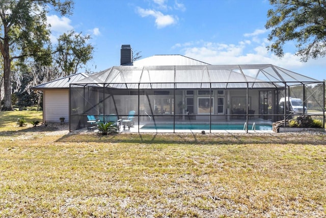 view of swimming pool with a yard and a lanai