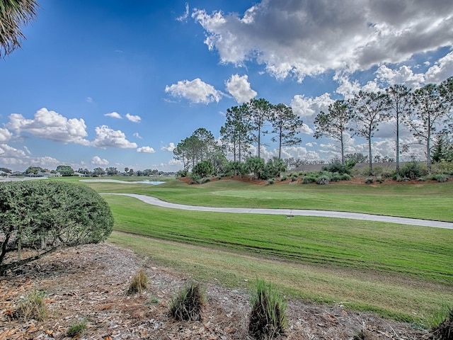 view of home's community featuring a yard and golf course view