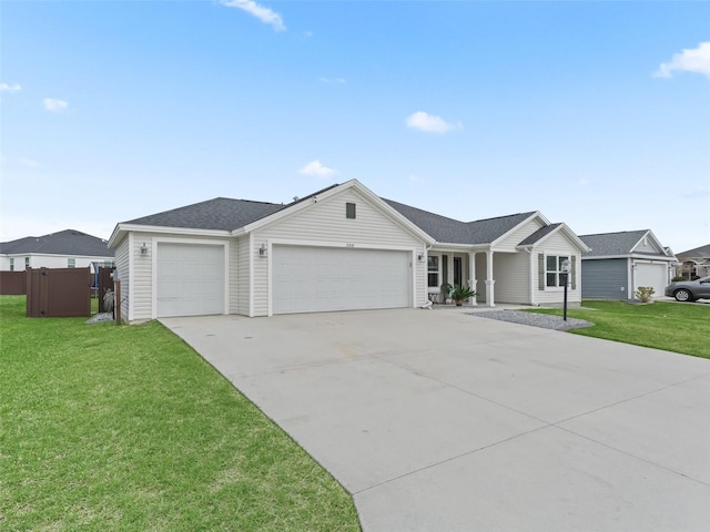 single story home with driveway, a front lawn, an attached garage, and fence