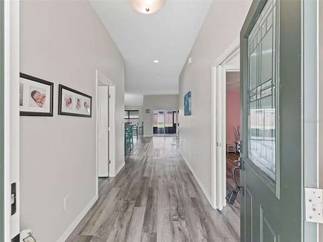 hallway with baseboards and light wood-style floors