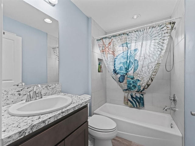 full bathroom with shower / bathtub combination with curtain, vanity, and toilet