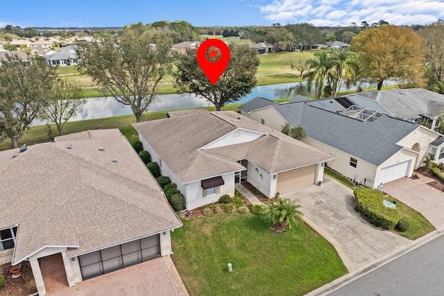 drone / aerial view featuring a water view and a residential view