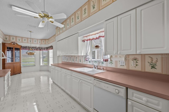 kitchen featuring white cabinetry, dishwasher, a textured ceiling, and a sink