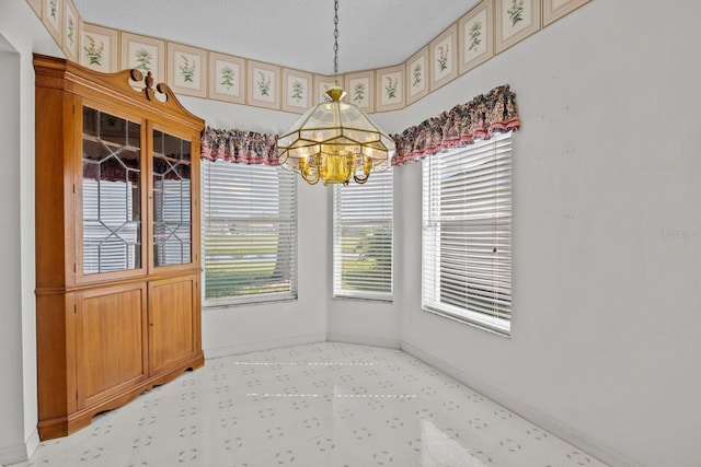 dining room with a notable chandelier and baseboards