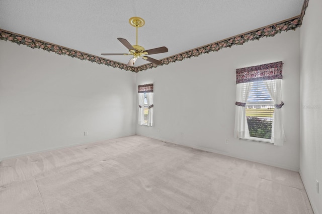 unfurnished room featuring carpet flooring, ceiling fan, and a textured ceiling