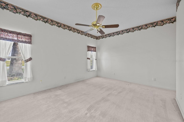 carpeted empty room featuring a ceiling fan