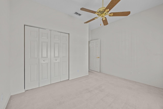 unfurnished bedroom with carpet floors, a closet, visible vents, and a ceiling fan