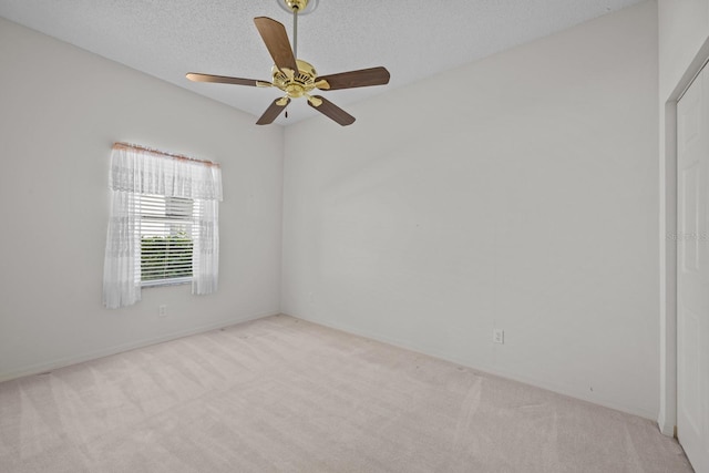 unfurnished room featuring a ceiling fan, carpet, and a textured ceiling