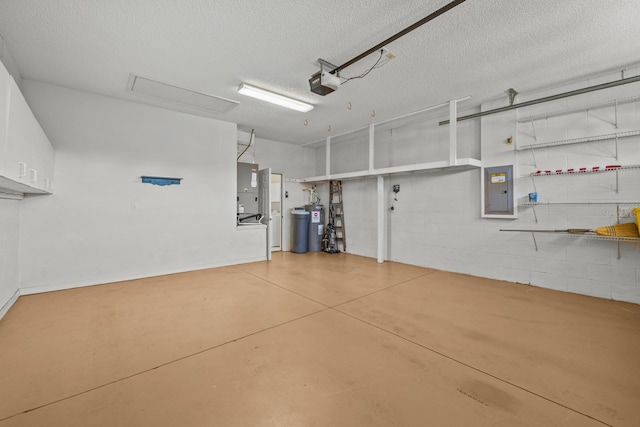 garage featuring concrete block wall, electric panel, and a garage door opener