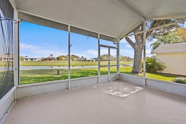 unfurnished sunroom featuring lofted ceiling and a water view