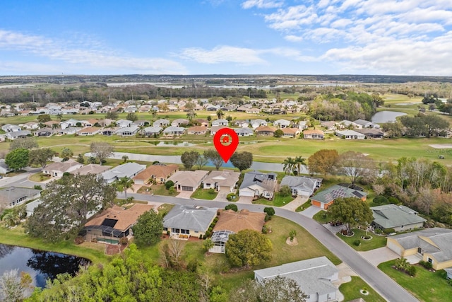 birds eye view of property featuring view of golf course, a water view, and a residential view