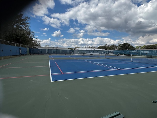 view of sport court featuring fence