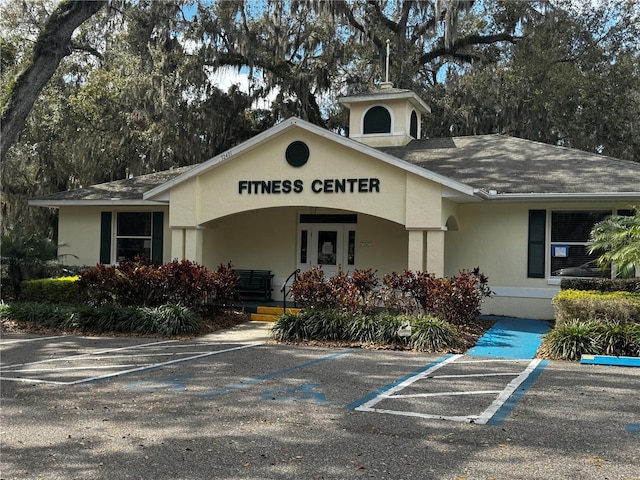 view of building exterior featuring uncovered parking