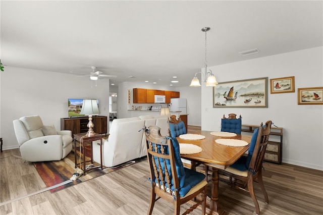 620 Vagabond St, The Villages, FL 32163 - dining space featuring recessed lighting, visible vents, light wood-style floors, baseboards, and ceiling fan with notable chandelier
