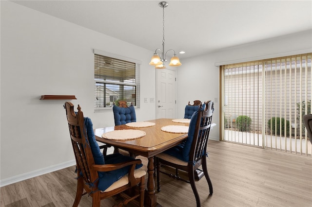 620 Vagabond St, The Villages, FL 32163 - dining area featuring light wood-style flooring, baseboards, and an inviting chandelier