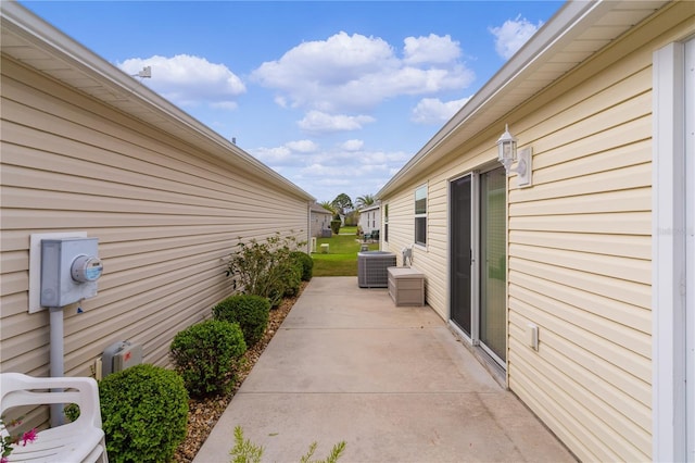 620 Vagabond St, The Villages, FL 32163 - view of side of home with a patio area and central air condition unit