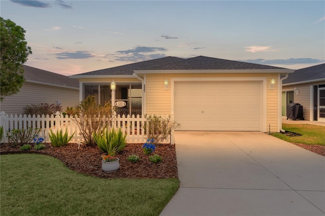 620 Vagabond St, The Villages, FL 32163 - view of front of property with concrete driveway, roof with shingles, an attached garage, fence, and a front yard