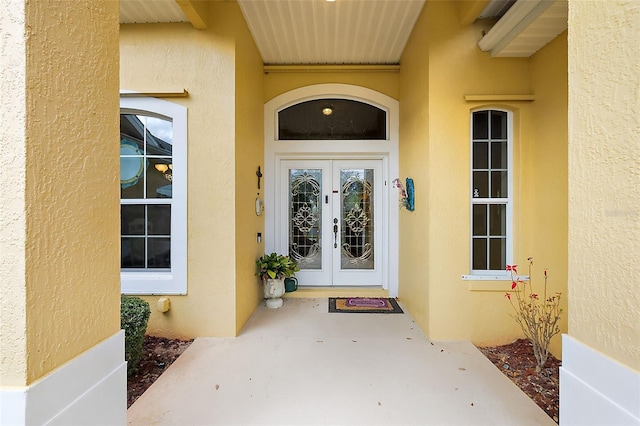 doorway to property with french doors and stucco siding