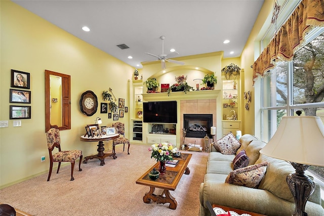 carpeted living room with recessed lighting, visible vents, ceiling fan, and a tile fireplace