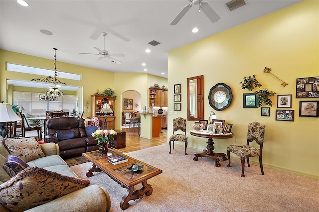 living room with arched walkways, visible vents, and ceiling fan