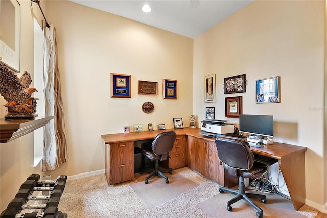 office space featuring baseboards and light colored carpet