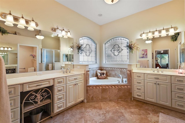 full bath featuring a shower stall, a bath, and vanity