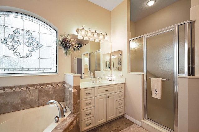 bathroom featuring a garden tub, tile patterned floors, a stall shower, and vanity