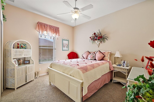 carpeted bedroom with visible vents, a ceiling fan, and baseboards