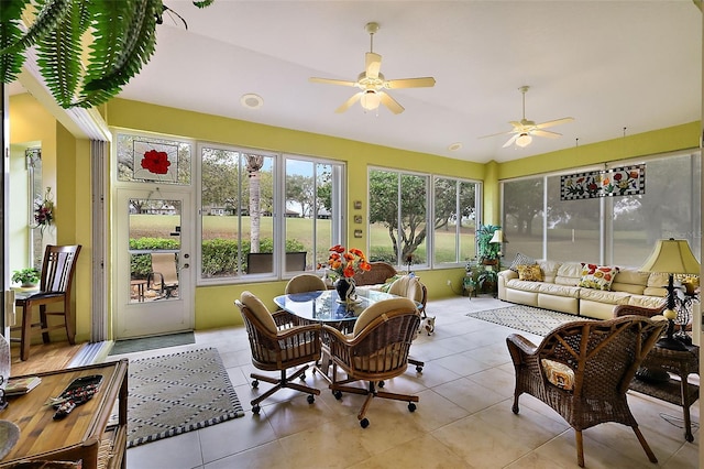 sunroom / solarium with a ceiling fan