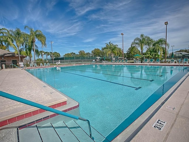 view of pool featuring fence