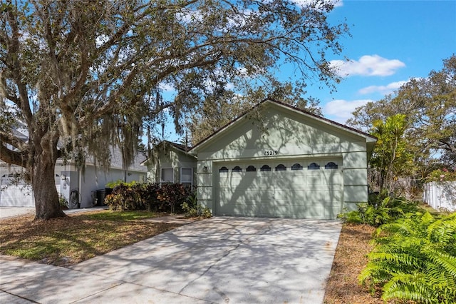 ranch-style house with concrete driveway and an attached garage