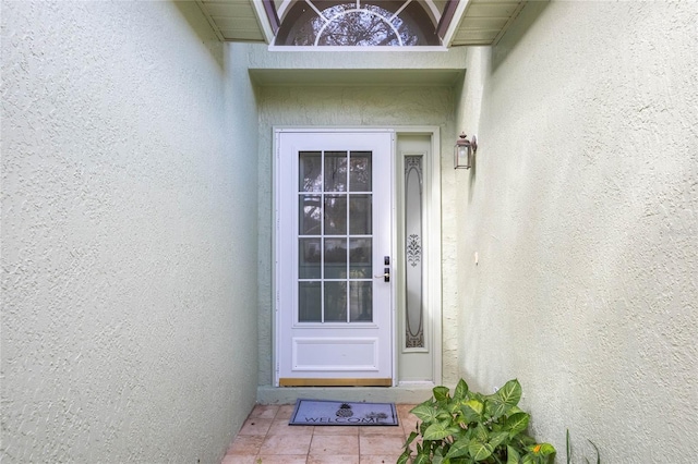 property entrance with stucco siding