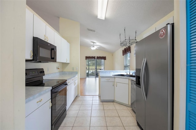 kitchen featuring light tile patterned floors, a sink, visible vents, light countertops, and black appliances