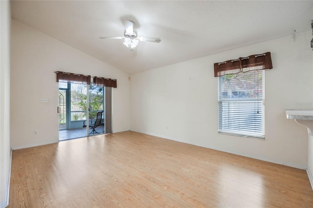 unfurnished room with a ceiling fan, lofted ceiling, baseboards, and wood finished floors