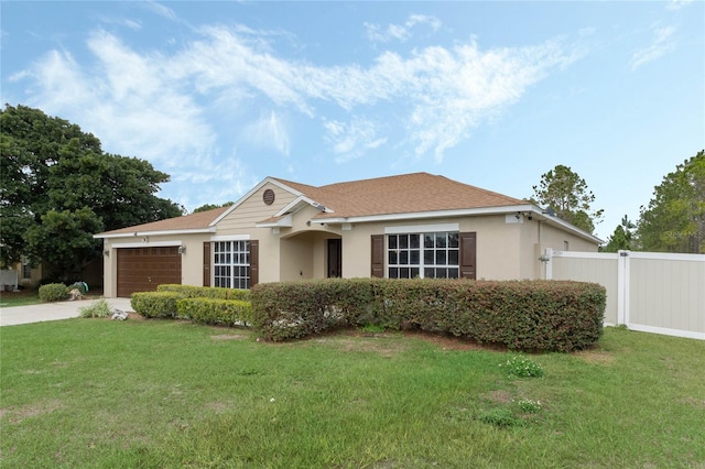 ranch-style home with a garage and a front yard