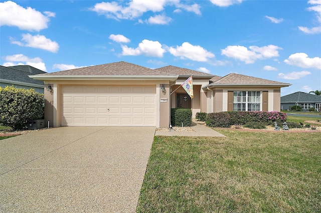 view of front facade with a garage, a front yard, concrete driveway, and stucco siding