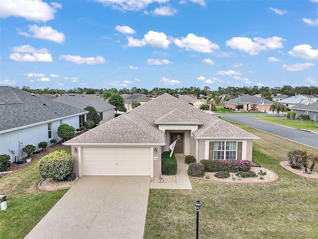 view of front of house featuring driveway, a garage, a residential view, roof with shingles, and a front yard