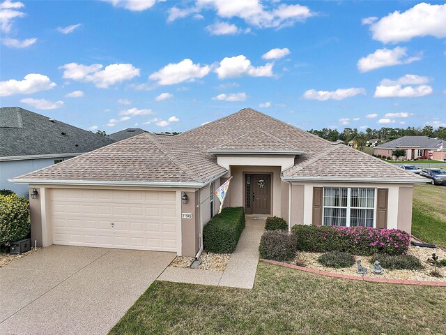 single story home with a front yard, concrete driveway, roof with shingles, and stucco siding