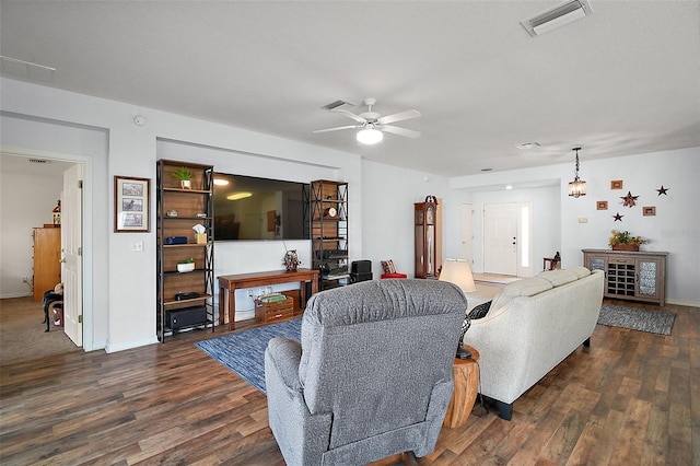 living area with ceiling fan, dark wood finished floors, visible vents, and baseboards