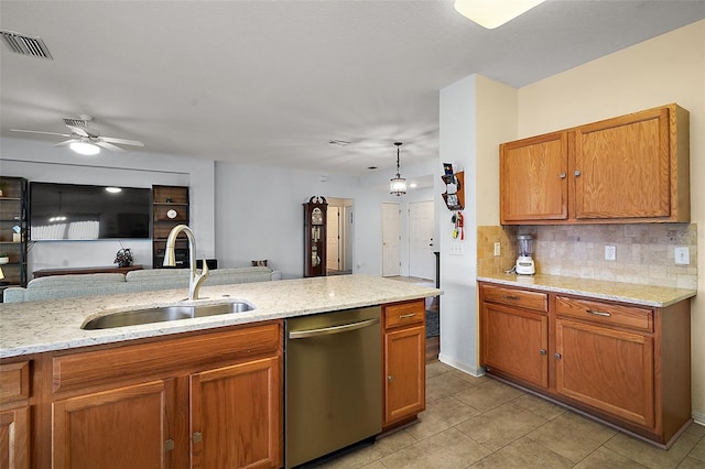 kitchen with a sink, visible vents, stainless steel dishwasher, tasteful backsplash, and brown cabinetry