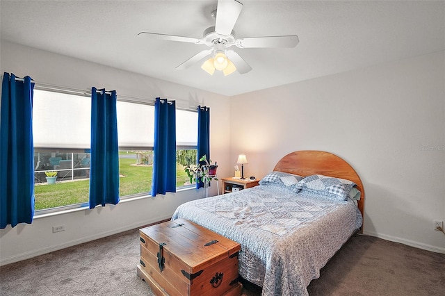 carpeted bedroom with baseboards and a ceiling fan