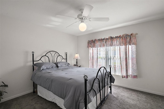 bedroom featuring dark colored carpet, ceiling fan, and baseboards