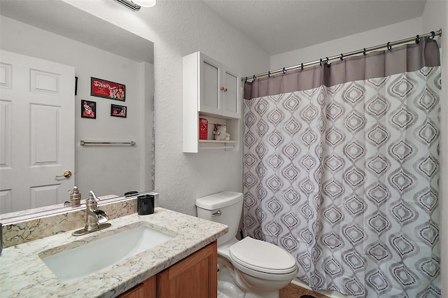 full bath featuring toilet, a textured wall, a shower with shower curtain, and vanity