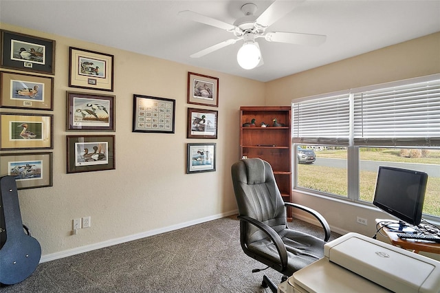 carpeted office featuring ceiling fan and baseboards