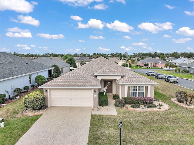 view of front of home with a garage, a shingled roof, concrete driveway, a residential view, and a front yard