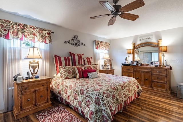 bedroom with dark hardwood / wood-style flooring and ceiling fan