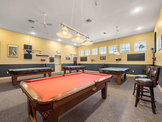 rec room featuring plenty of natural light, carpet floors, and a textured ceiling