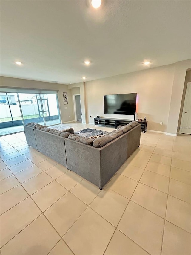 living area with light tile patterned floors, baseboards, and recessed lighting