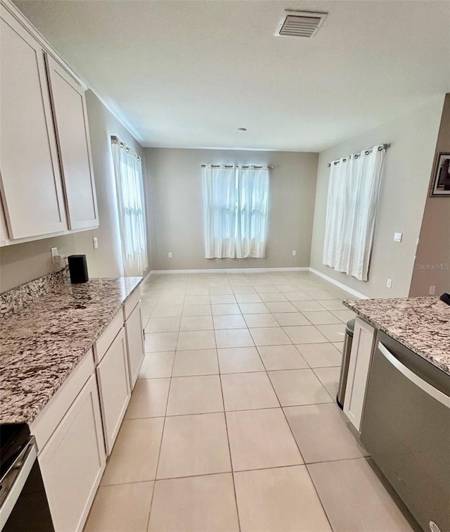 kitchen with white cabinetry, light tile patterned floors, plenty of natural light, and visible vents