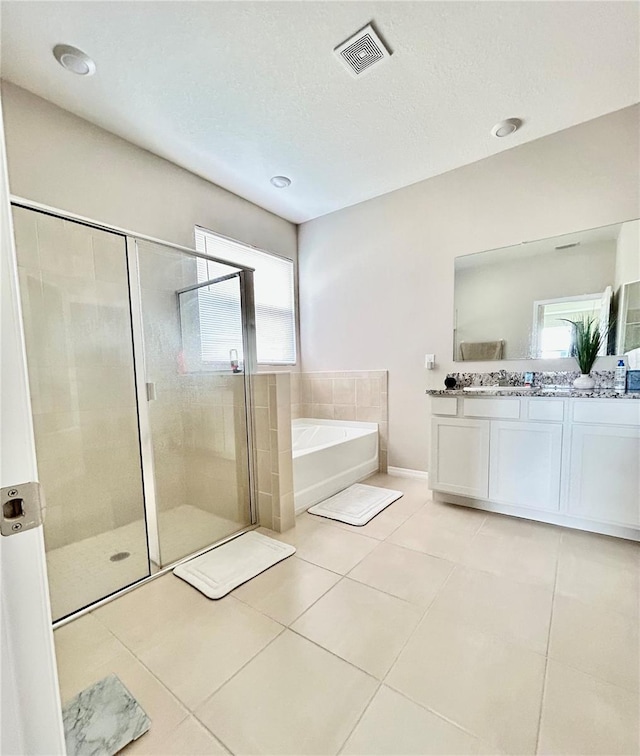 bathroom with a stall shower, visible vents, a bath, and tile patterned floors